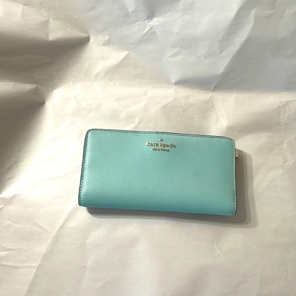 Slim bifold leather wallet by Kate Spade New York.